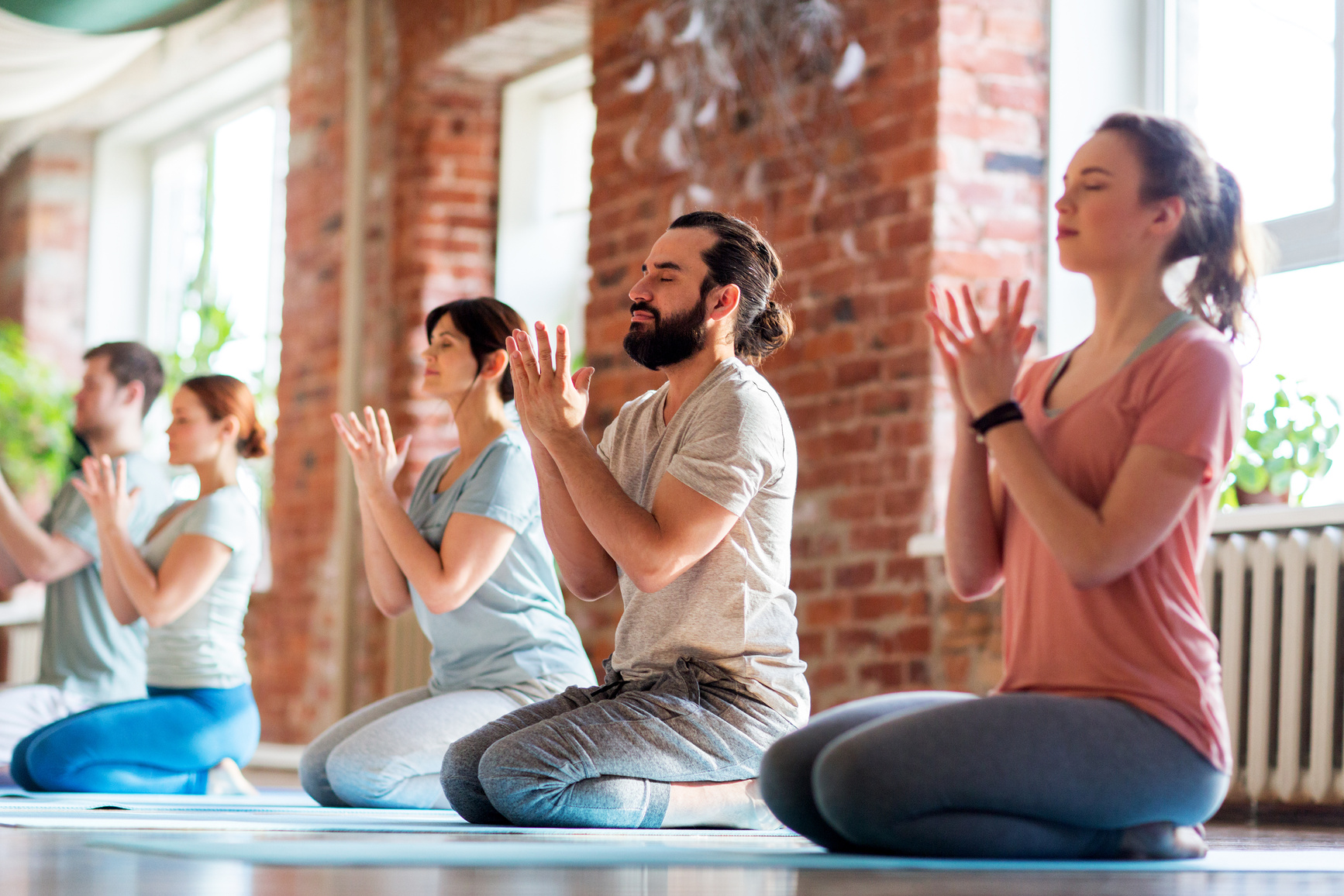 Group of People Meditating at Yoga Studio
